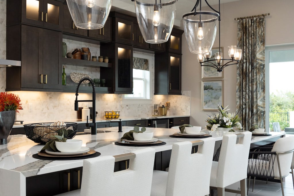 Modern kitchen with floating cabinets, big island, and nice lighting