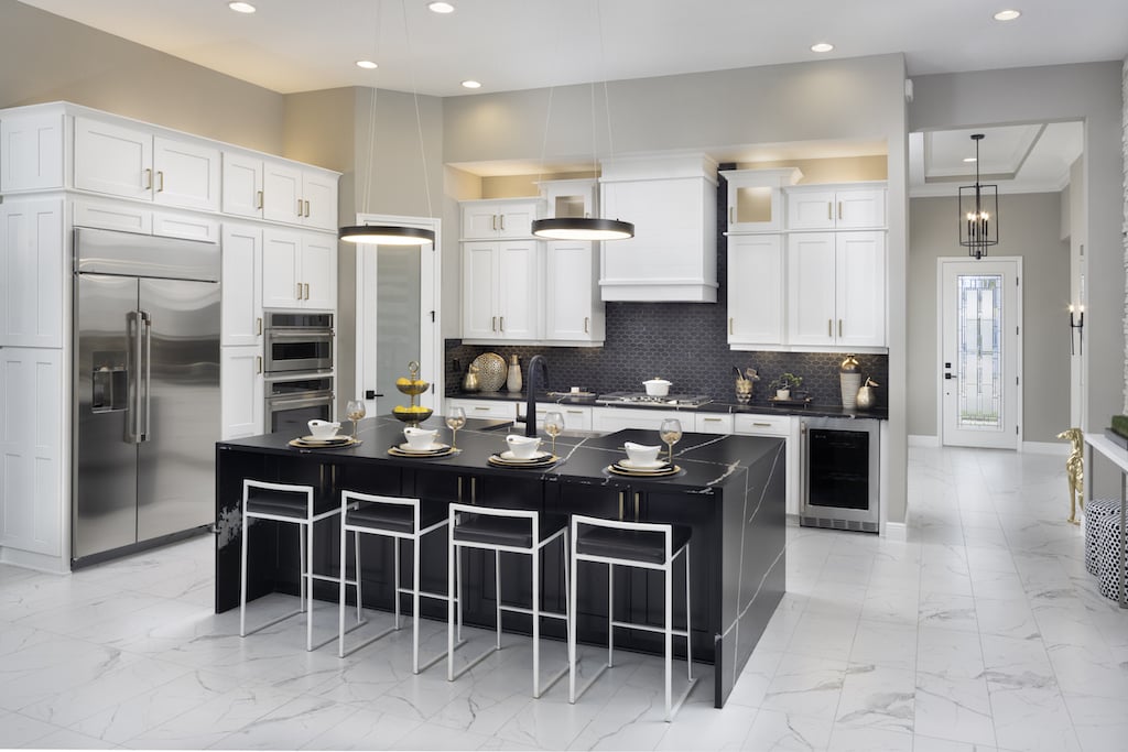 Open concept modern kitchen with white cabinets and black island